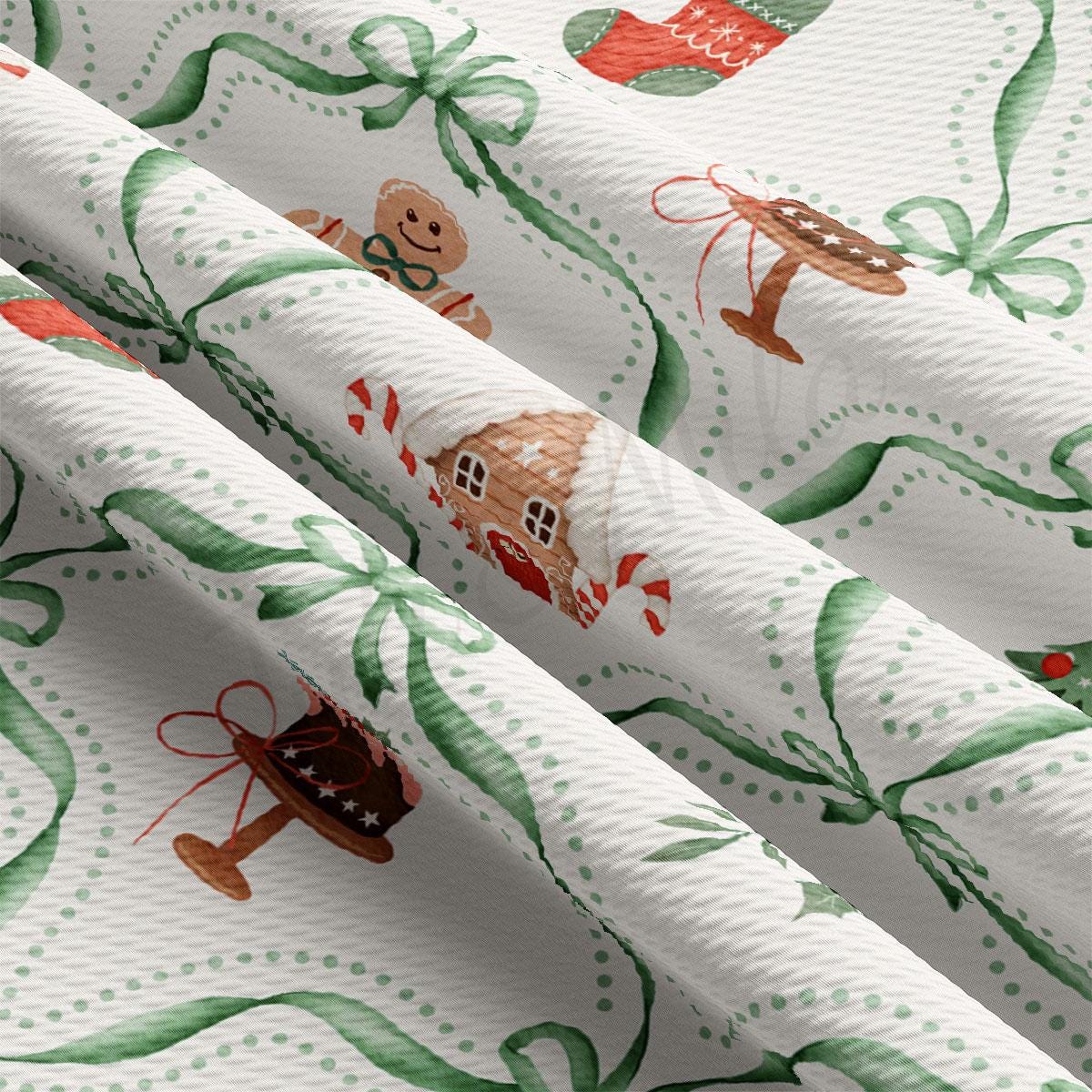 a close-up view of a fabric with a Christmas-themed pattern. The fabric has green and white colors and is adorned with various Christmas-themed illustrations, including a gingerbread house, a teddy bear, and other festive elements. The fabric appears to be made of a soft, plush material, suitable for holiday-themed clothing or home decor items.