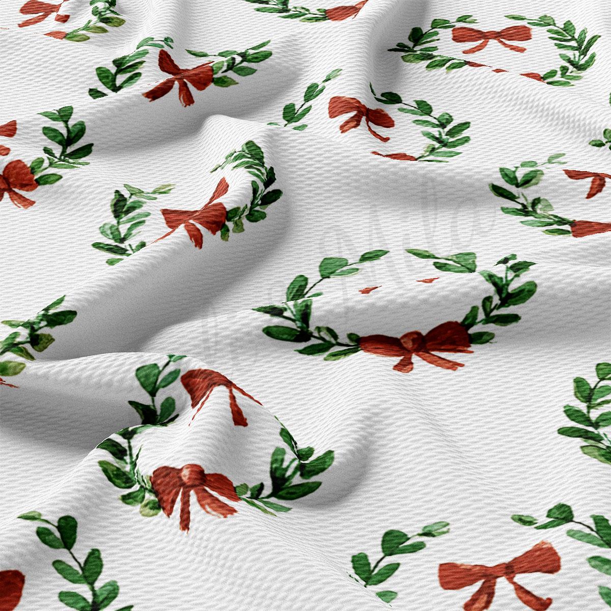 a close-up view of a fabric with a repeating pattern of red bows and green leaves, creating a festive and holiday-themed design.