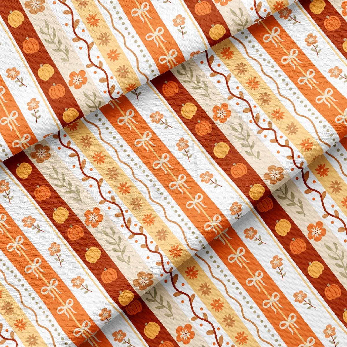 a repeating pattern of orange and white stripes with floral and pumpkin designs.