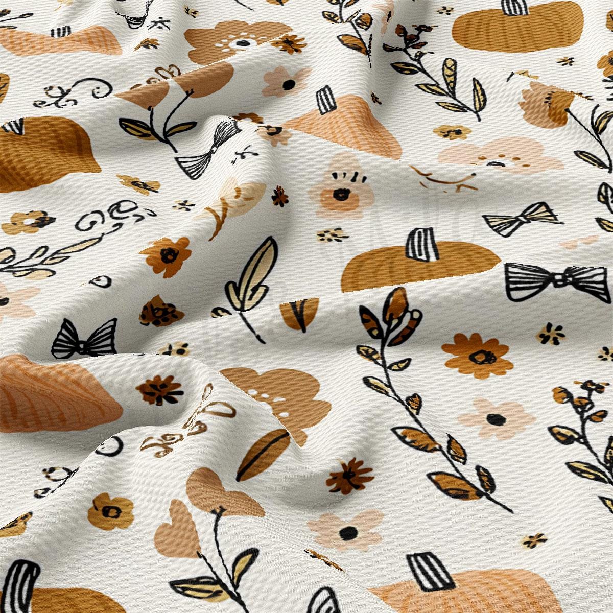 The image is a close-up view of a fabric with a repeating pattern of various floral and leaf designs in shades of brown and orange. The pattern includes leaves, flowers, and other natural elements, creating a visually appealing and textured design.