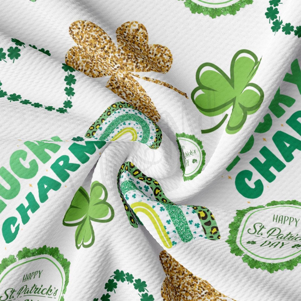 a close up of a white fabric with shamrocks on it
