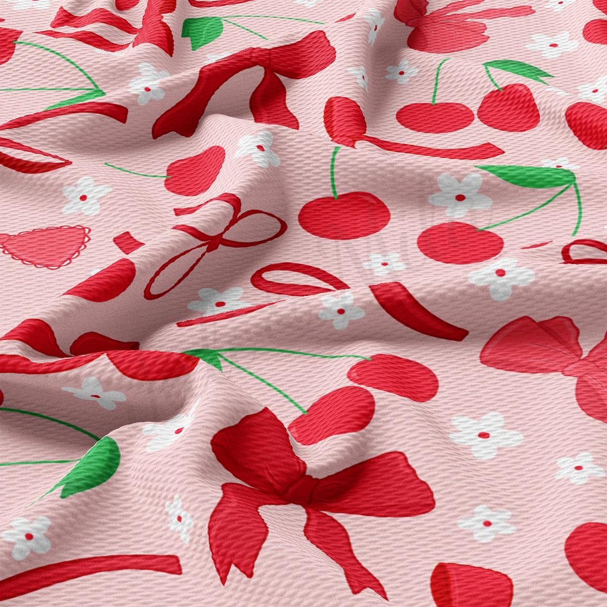 a close up of a pink fabric with cherries on it