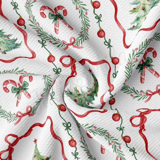 The image is a close-up of a fabric with a repeating pattern of Christmas-themed elements, including candy canes, Christmas trees, and red bows.