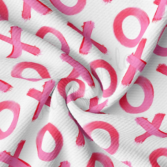 a white and pink fabric with pink letters on it