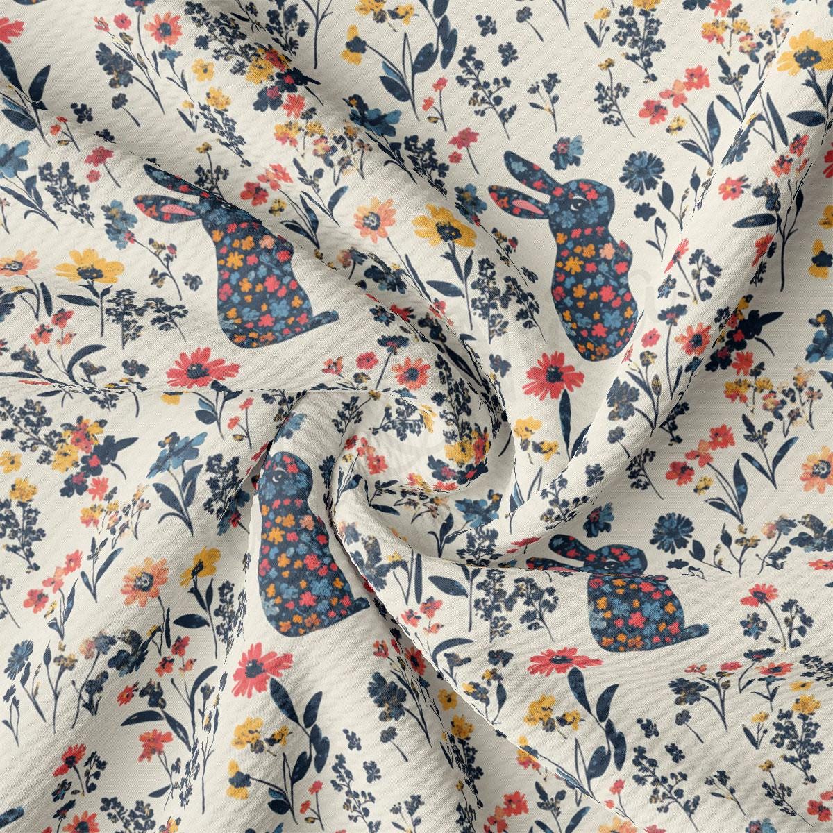 a white fabric with flowers and rabbits on it