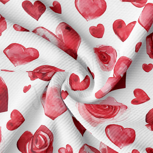 a close-up view of a fabric with a repeating pattern of red hearts and roses.