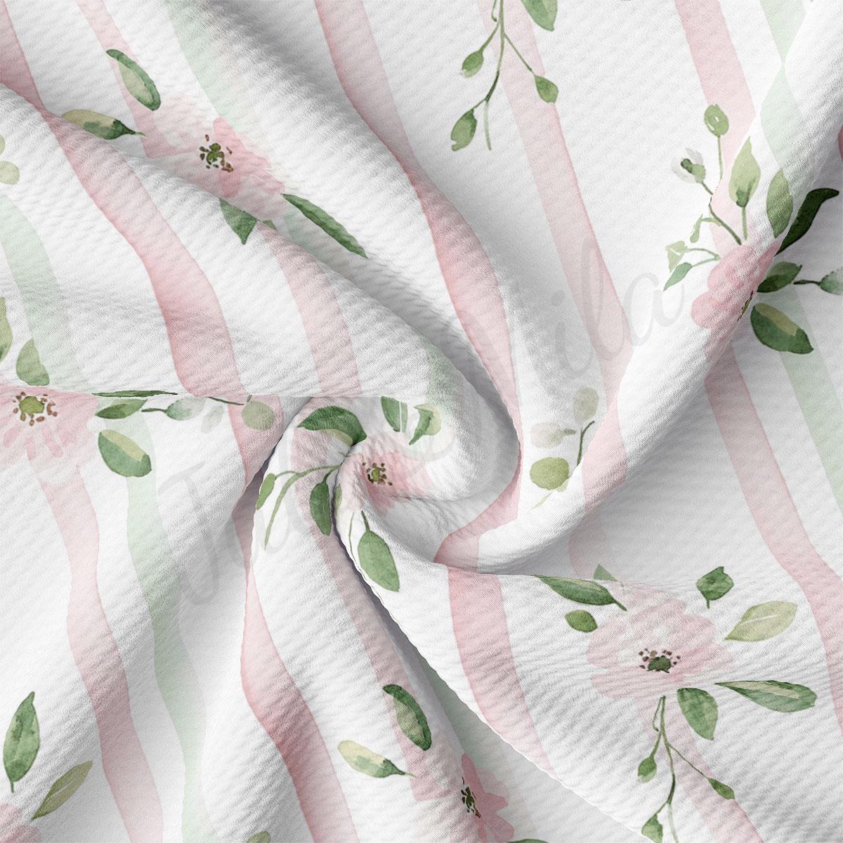 a close-up view of a fabric with a floral pattern of pink and green stripes and leaves.