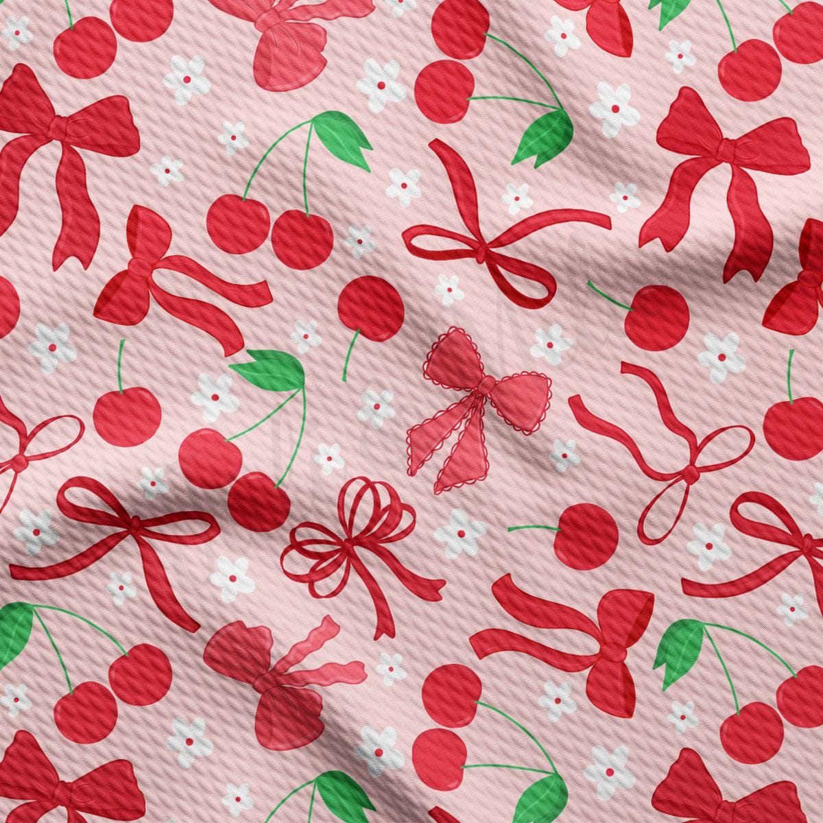 a pattern of cherries and bows on a pink background