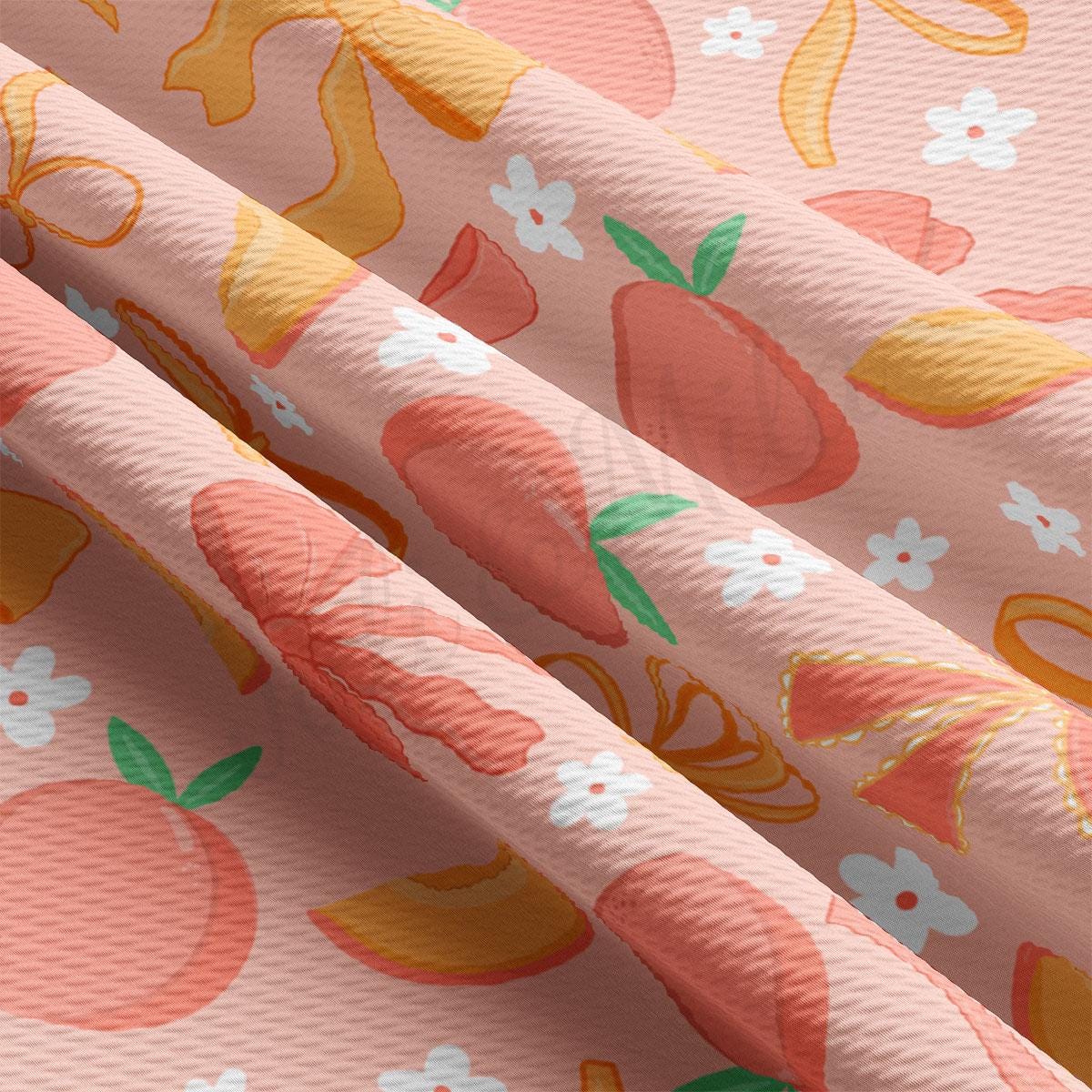 a close up of a pink fabric with oranges and apples on it