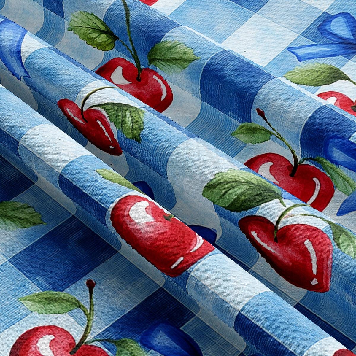 a blue and white checkered table cloth with cherries on it