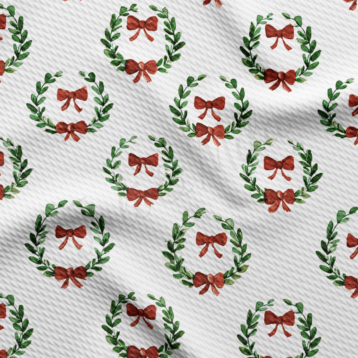 a repeating pattern of green wreaths with red bows on a white background.