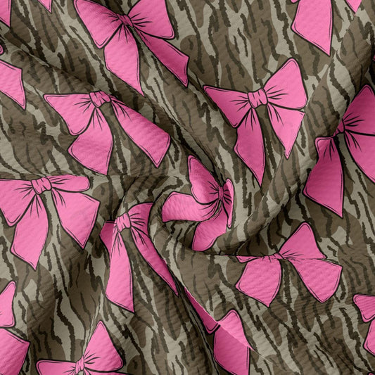 a pink and brown pattern with bows on it