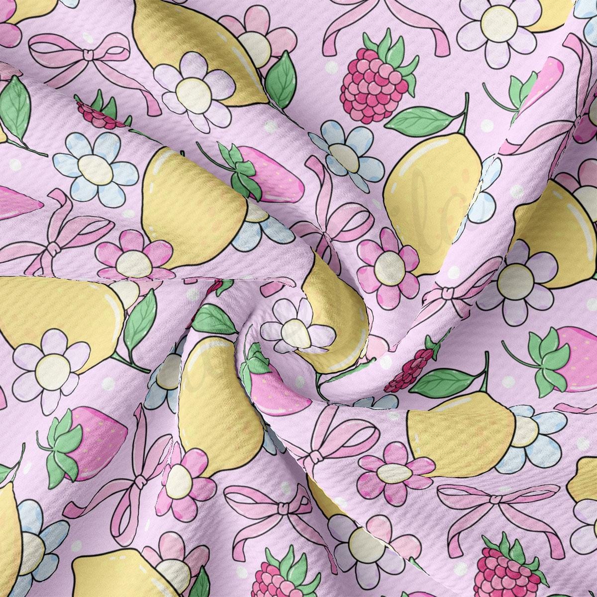 a close up of a pink fabric with lemons and berries on it