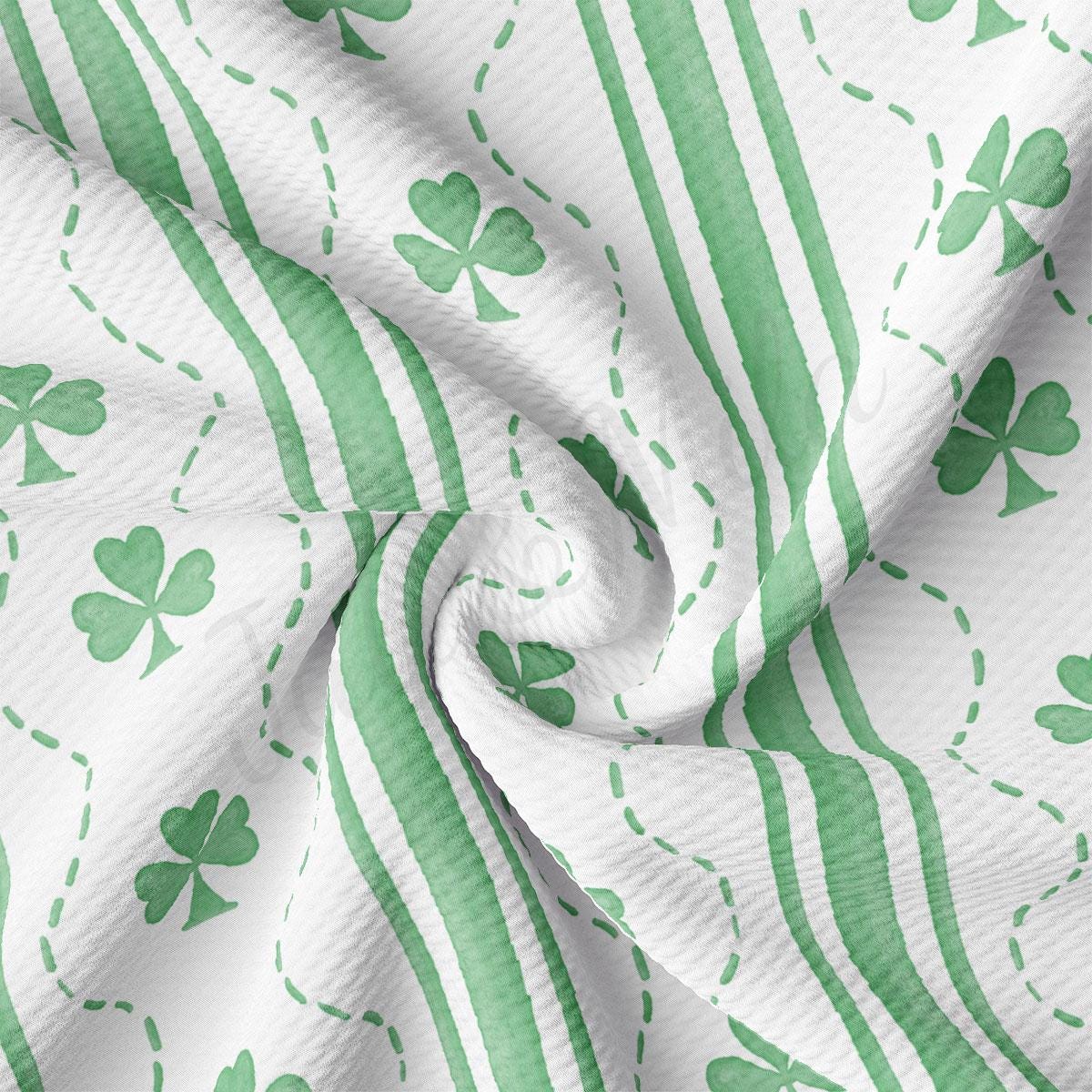 a green and white striped fabric with shamrocks on it
