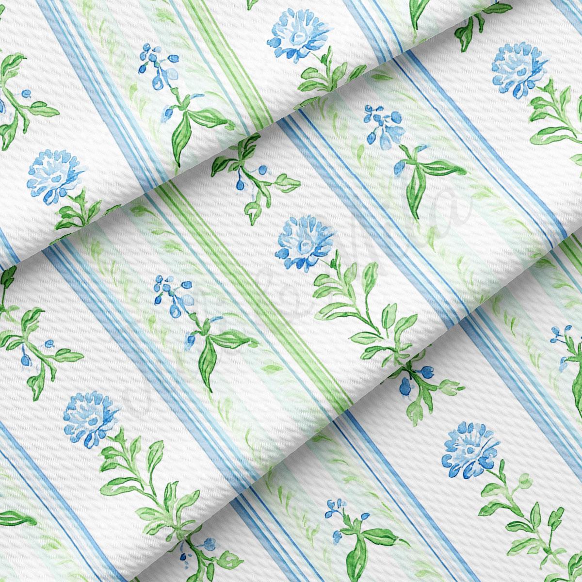 a repeating pattern of blue flowers and green leaves on a white background, creating a visually appealing and harmonious design.