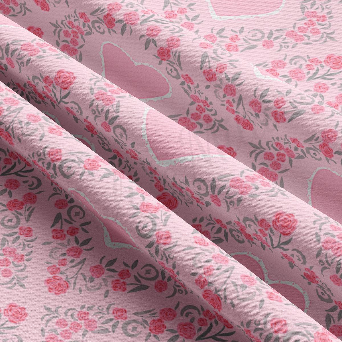 a close up of a pink fabric with hearts and flowers on it