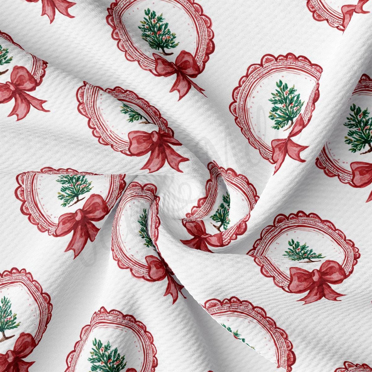 a close-up view of a fabric with a repeating pattern of red bows and Christmas trees, creating a festive and holiday-themed design.