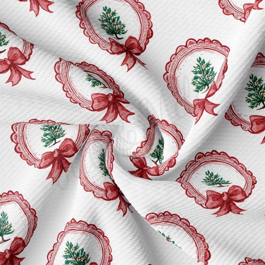 a close-up view of a fabric with a repeating pattern of red bows and Christmas trees, creating a festive and holiday-themed design.