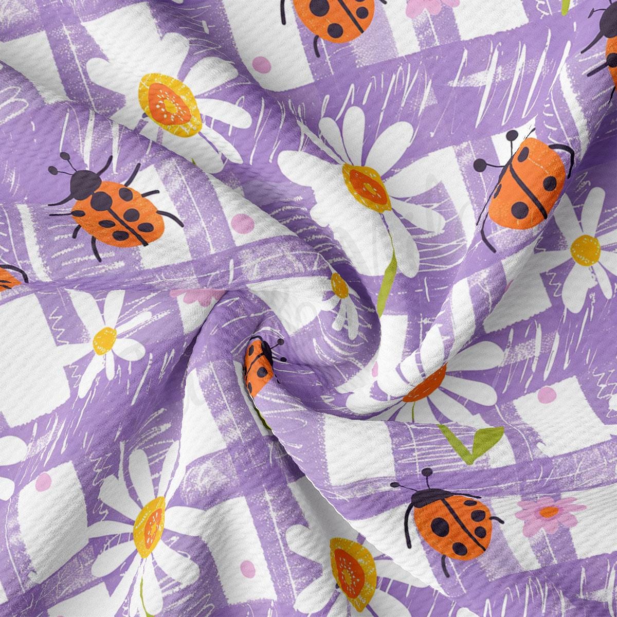 a purple and white fabric with ladybugs on it