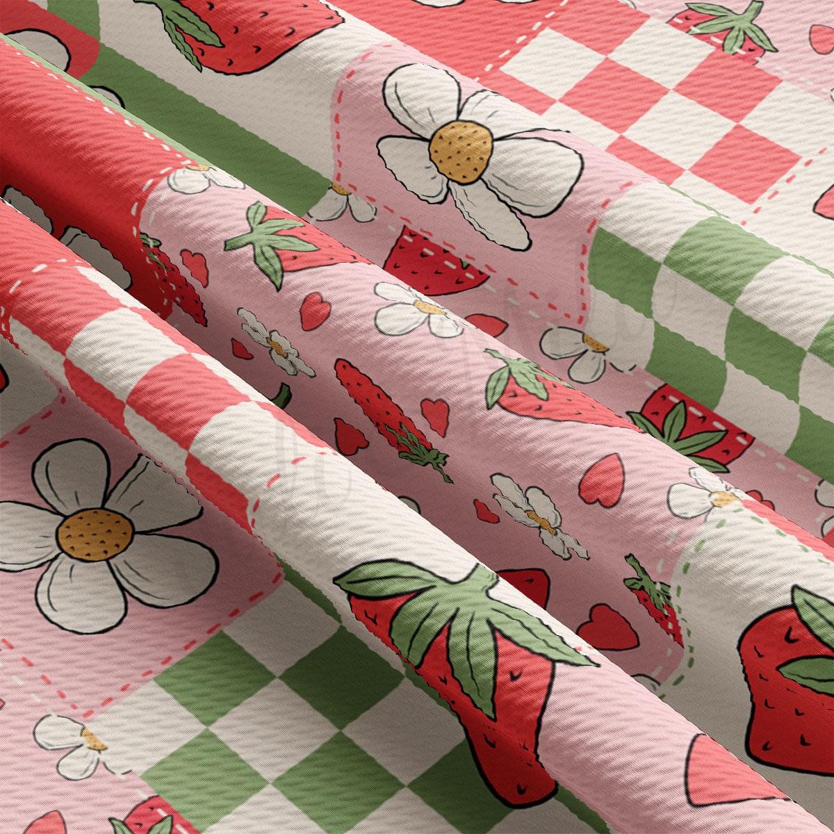 a pink and green checkered table cloth with strawberries on it