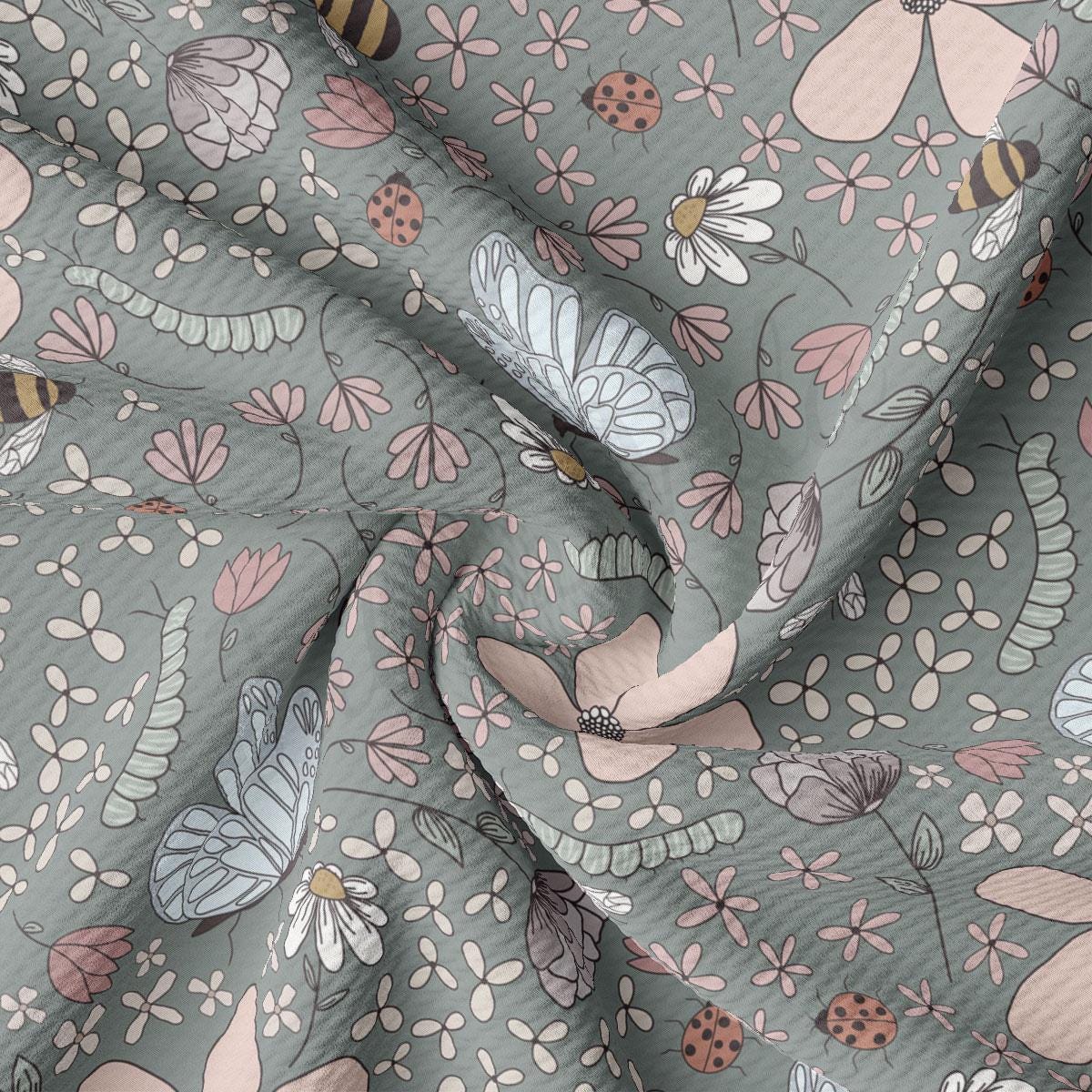 a close up of a fabric with flowers and bugs on it