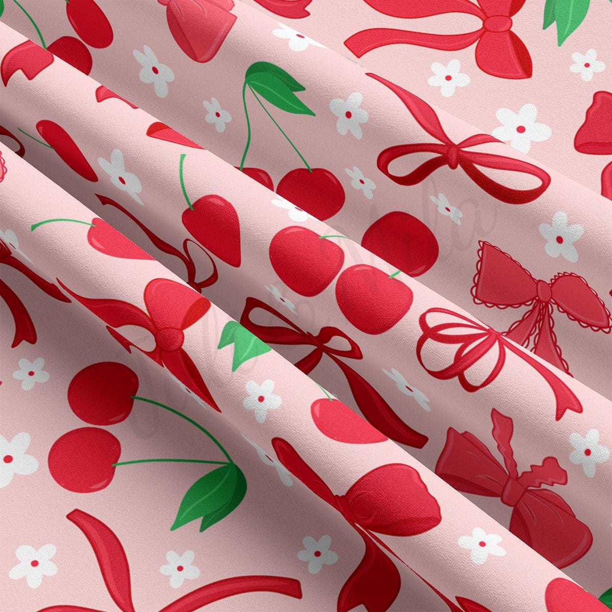 a pink background with red cherries and green leaves