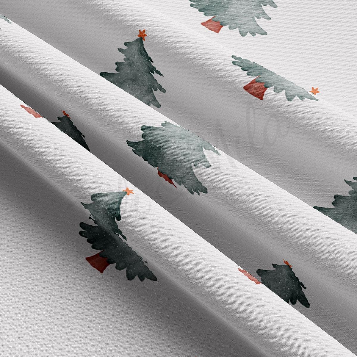 a close up of a white fabric with trees on it
