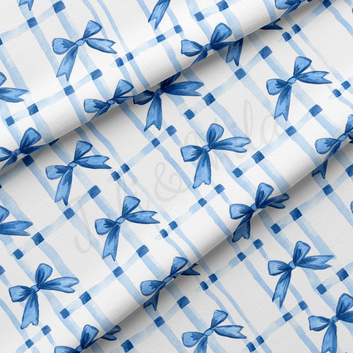 a blue and white checkered fabric with bows