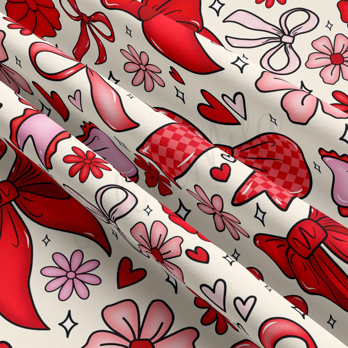 The image is a close-up of a fabric with a repeating pattern of red bows, hearts, and flowers on a white background.