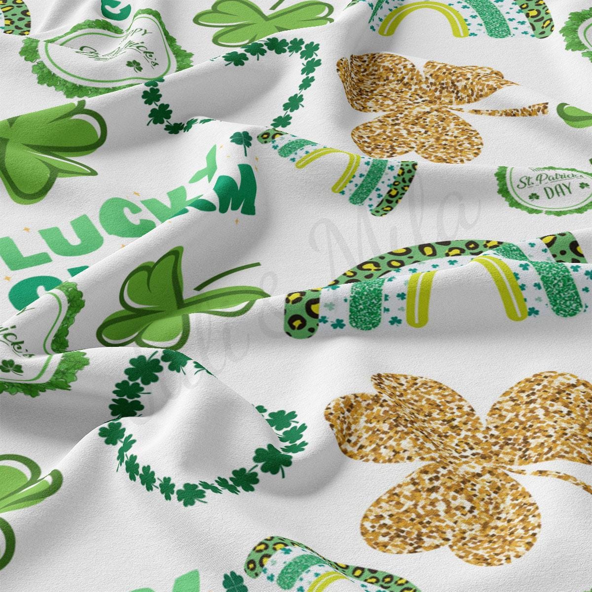 a close up of a white fabric with shamrocks
