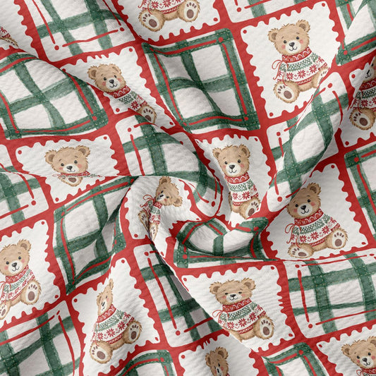 a fabric with a repeating pattern of teddy bears wearing Christmas sweaters. The teddy bears are arranged in a grid-like pattern, with some of them wearing red and green sweaters. The fabric appears to be made of a soft, plush material, suitable for winter wear or holiday-themed decorations.
