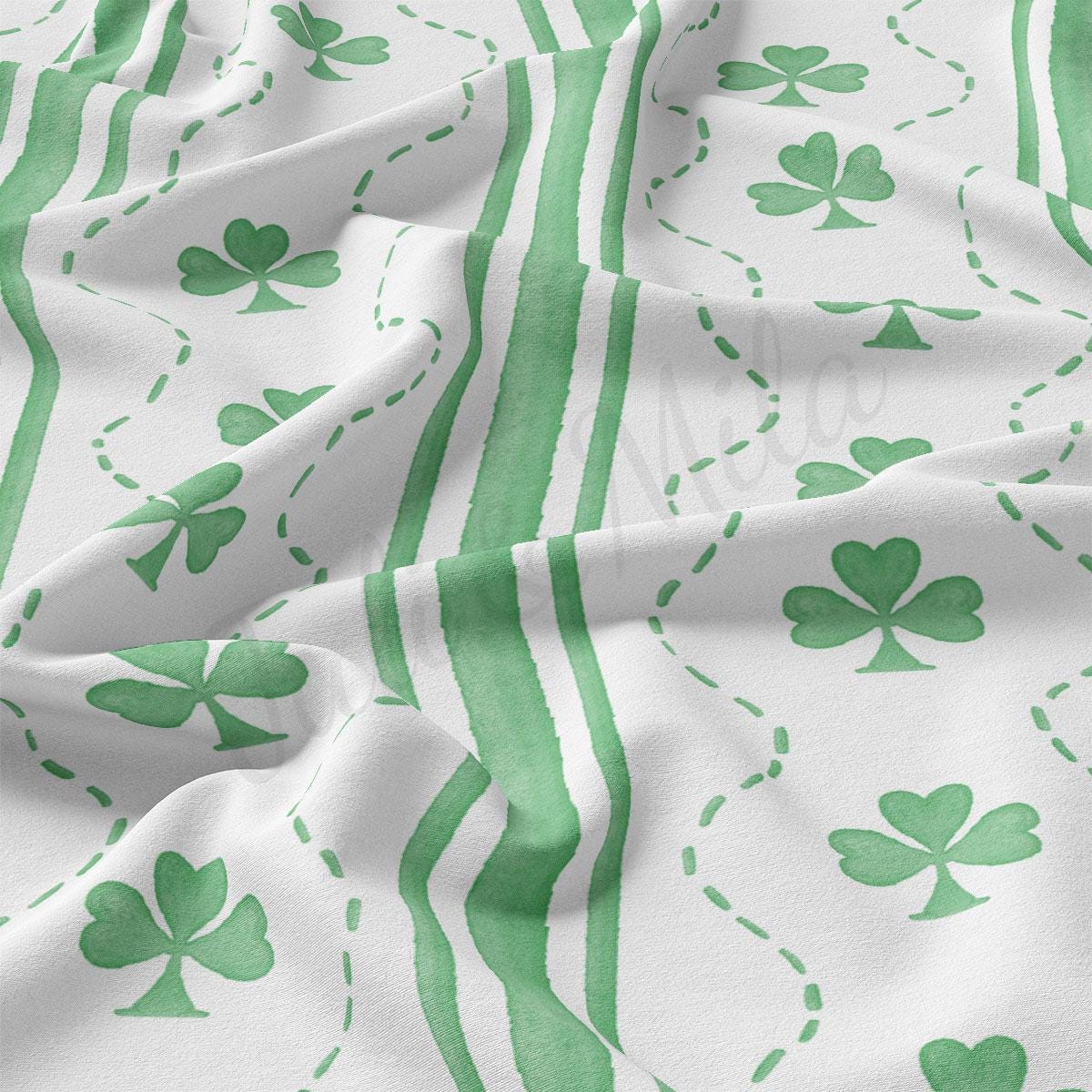a green and white fabric with shamrocks on it
