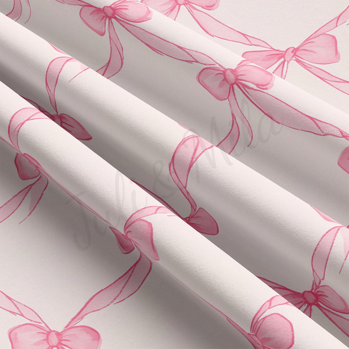 a close-up view of a fabric with a repeating pattern of pink bows on a white background.