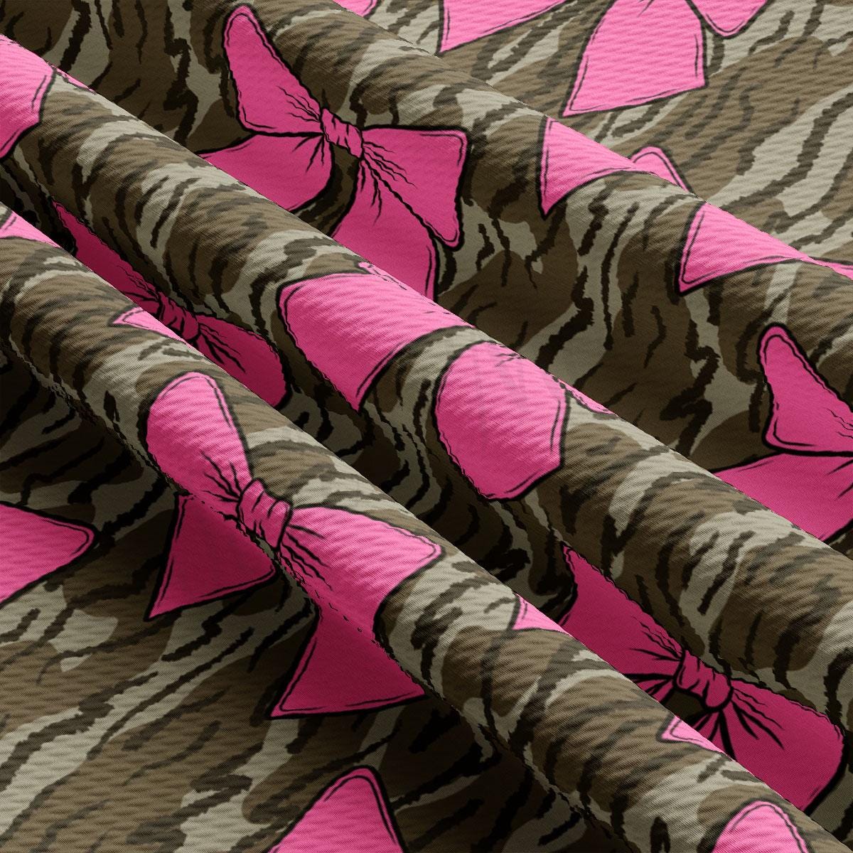 a close up of a pattern with pink bows