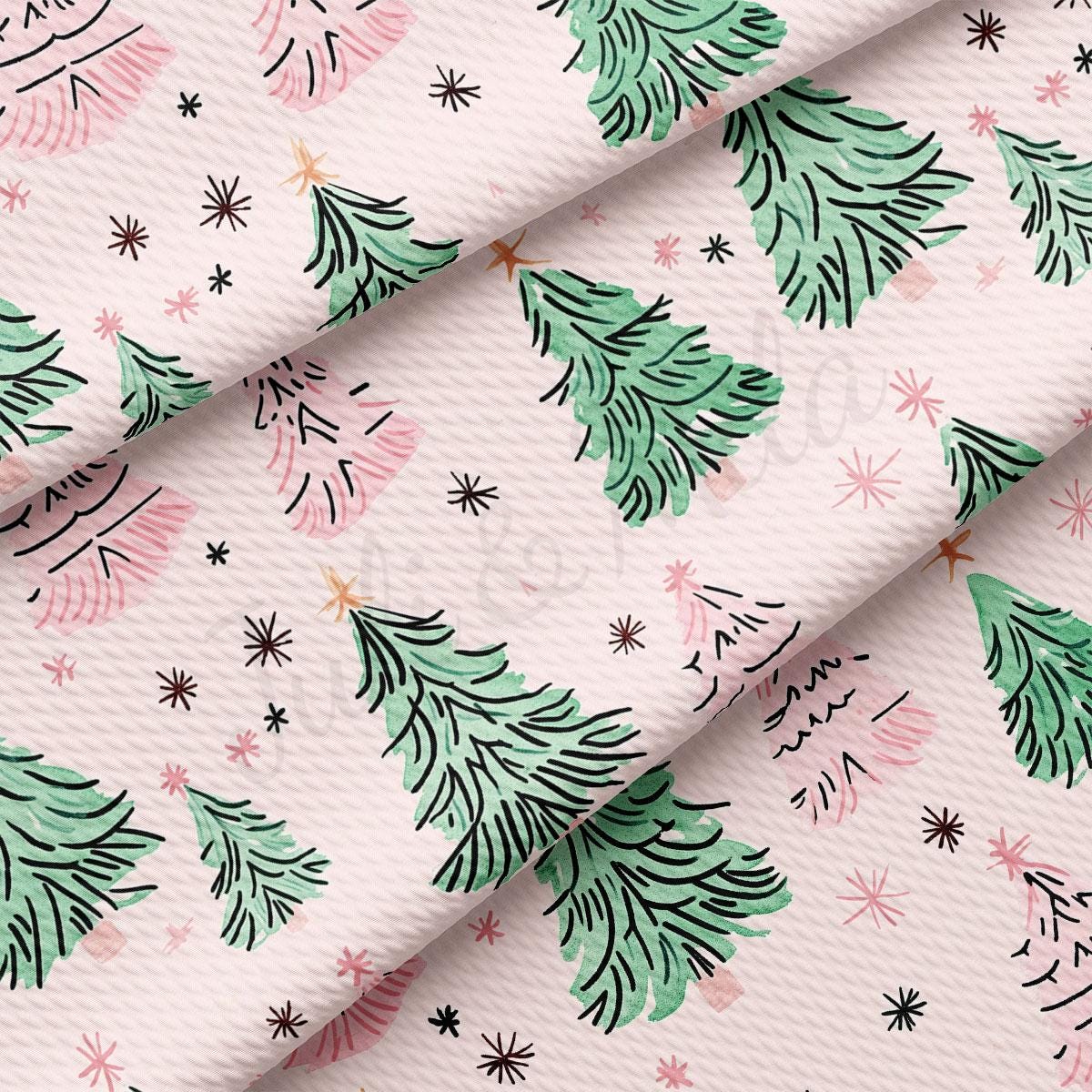 a repeating pattern of stylized Christmas trees in shades of pink and green, with scattered white stars.