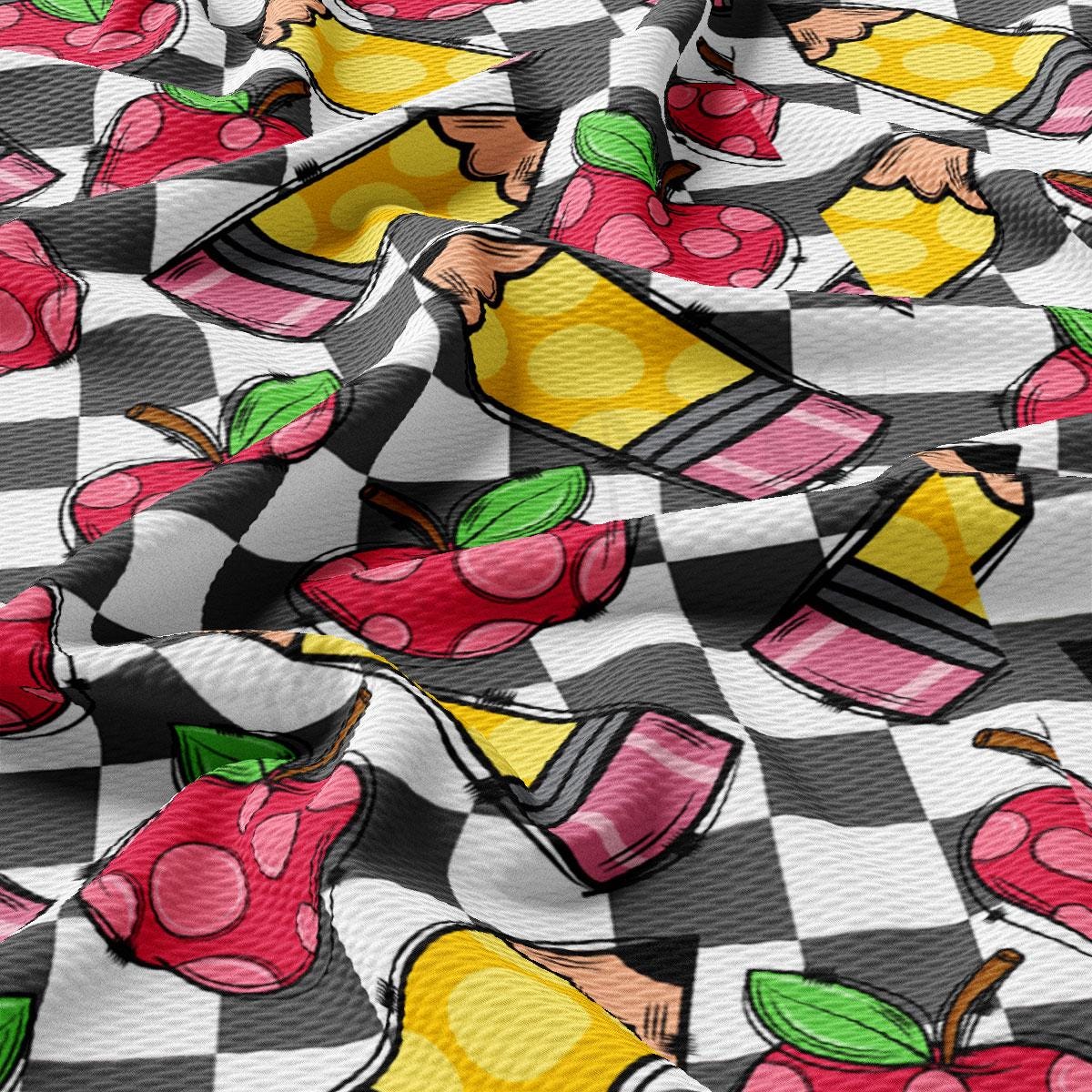a close up of a checkered fabric with apples on it