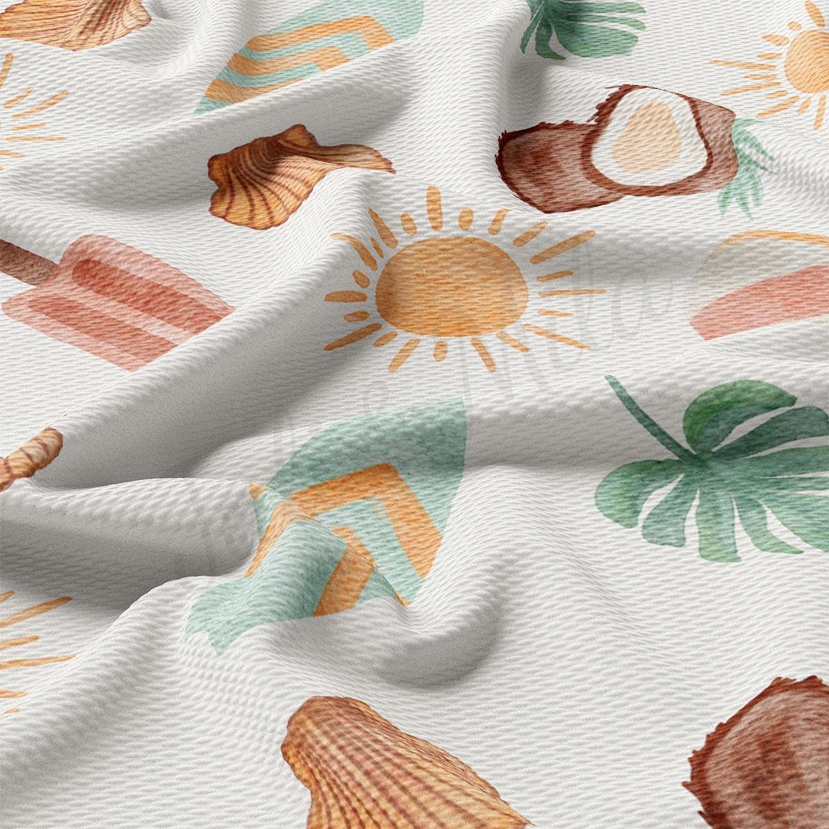 a close up of a white fabric with shells on it