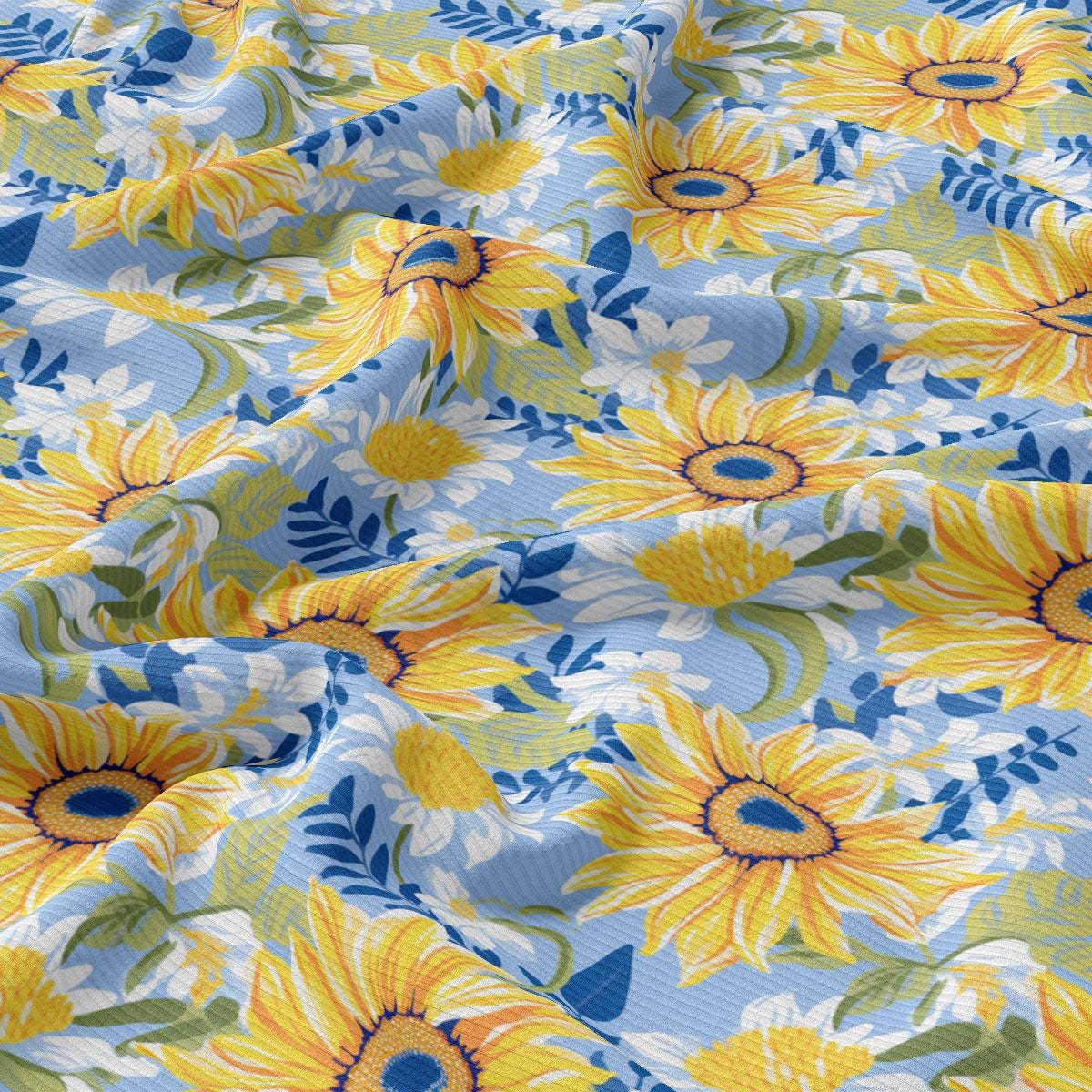 a blue and yellow flowered fabric with yellow flowers
