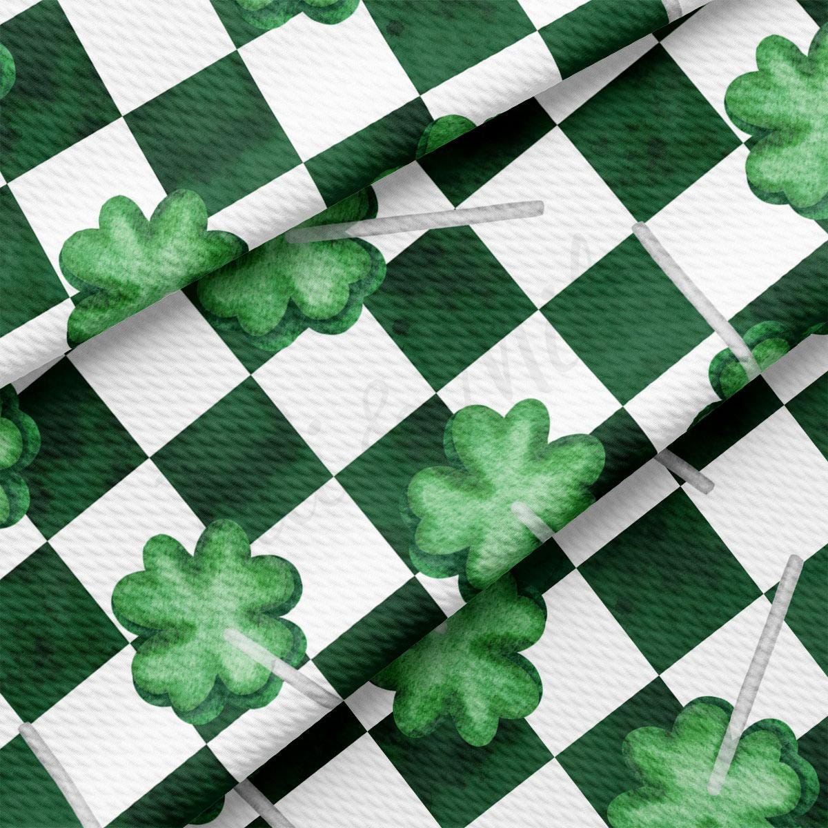 a green and white checkered pattern with shamrocks