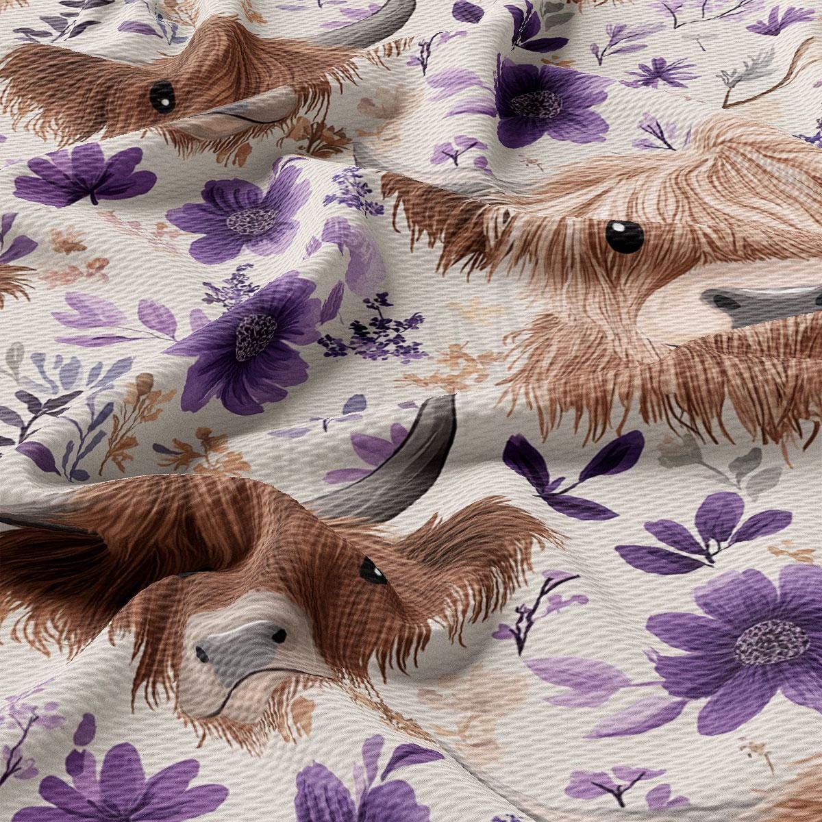 a close-up view of a fabric with a floral pattern, including purple flowers and brown animal features such as horns and a long neck.