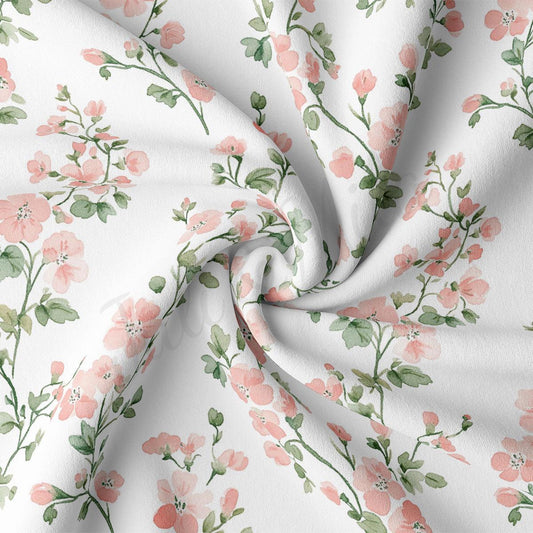 a close-up view of a fabric with a floral pattern of pink flowers and green leaves. The fabric appears to be white, and the pattern is intricate and detailed, with the flowers and leaves arranged in a repeating design across the fabric's surface.