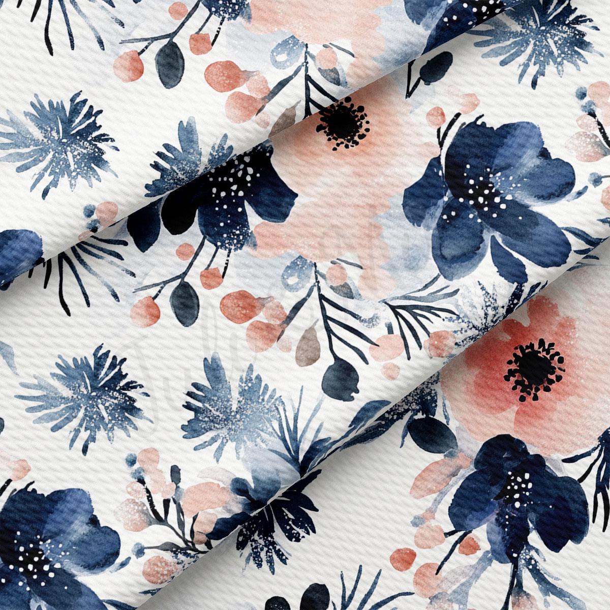 a close-up view of a fabric with a floral pattern. The pattern consists of various blue and pink flowers and leaves, creating a visually appealing and intricate design. The fabric appears to be made of a soft, textured material, which adds to the overall aesthetic of the image.