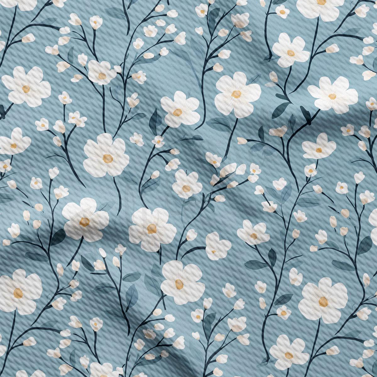 a repeating pattern of white flowers with green stems against a blue background.