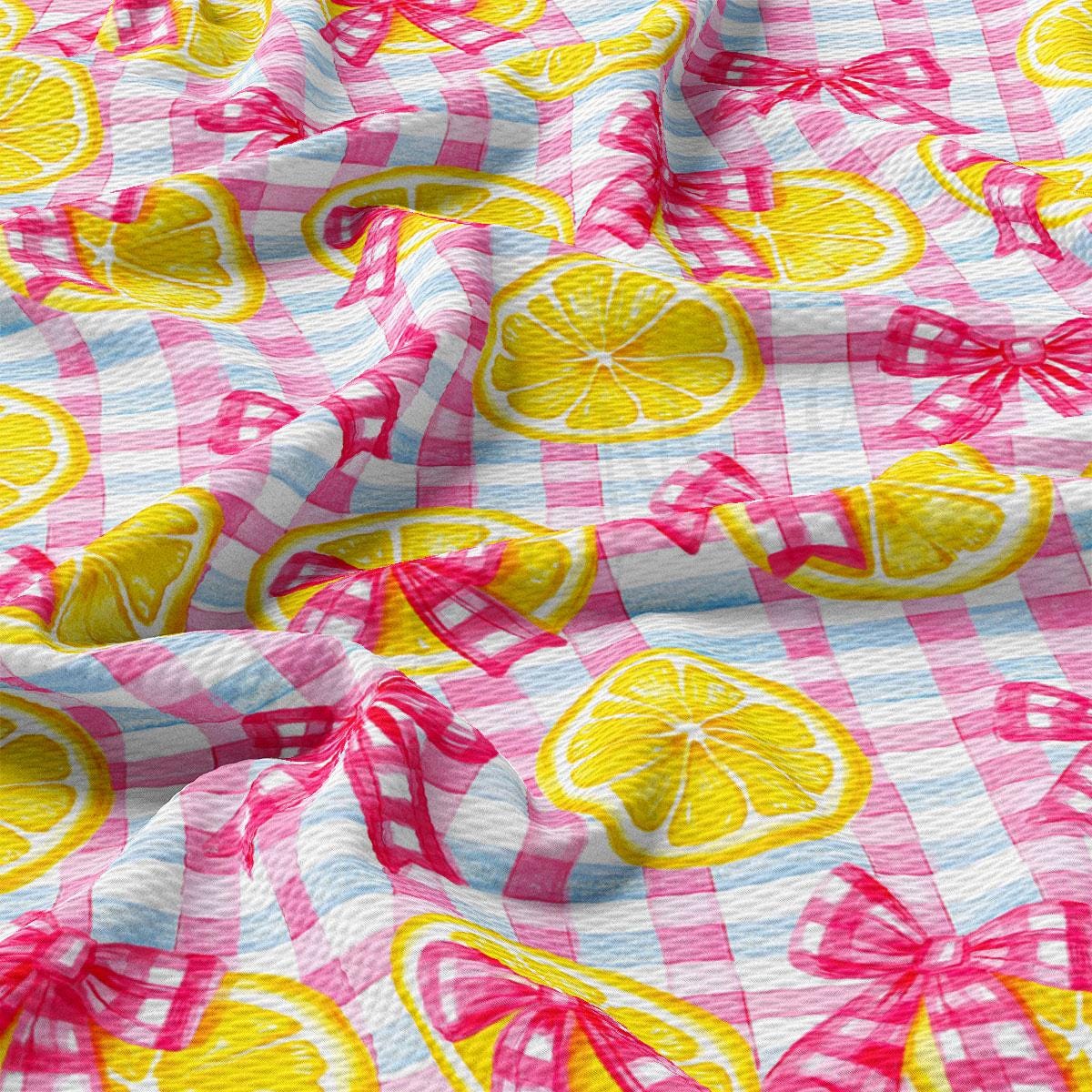a pink and yellow checkered fabric with lemons on it