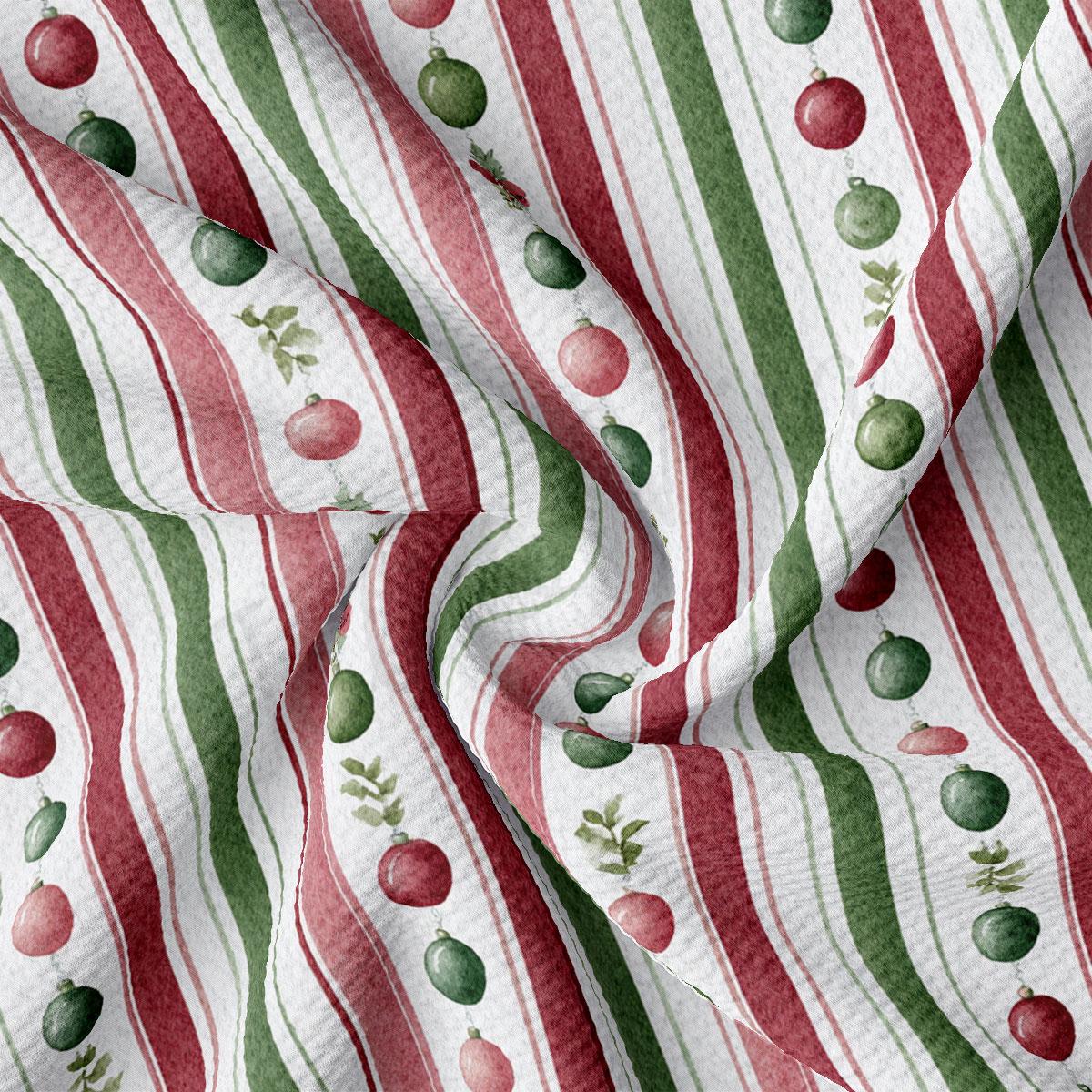 The image is a close-up of a fabric with a repeating pattern of red and green stripes, along with small green and red Christmas ornaments.