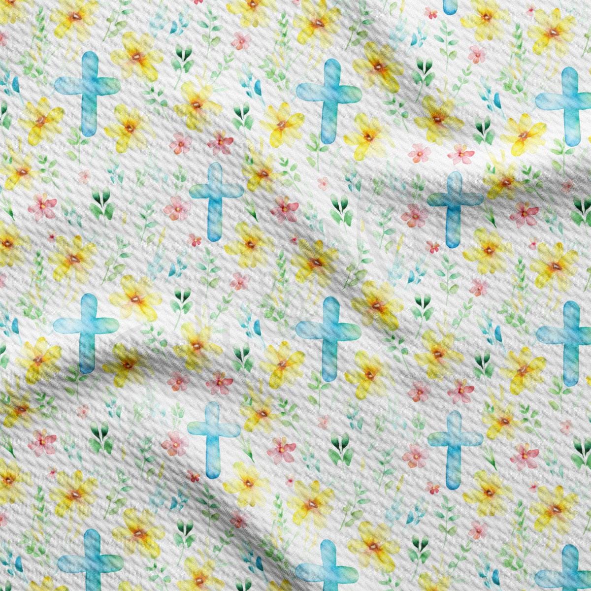 a close up of a white fabric with flowers and crosses on it