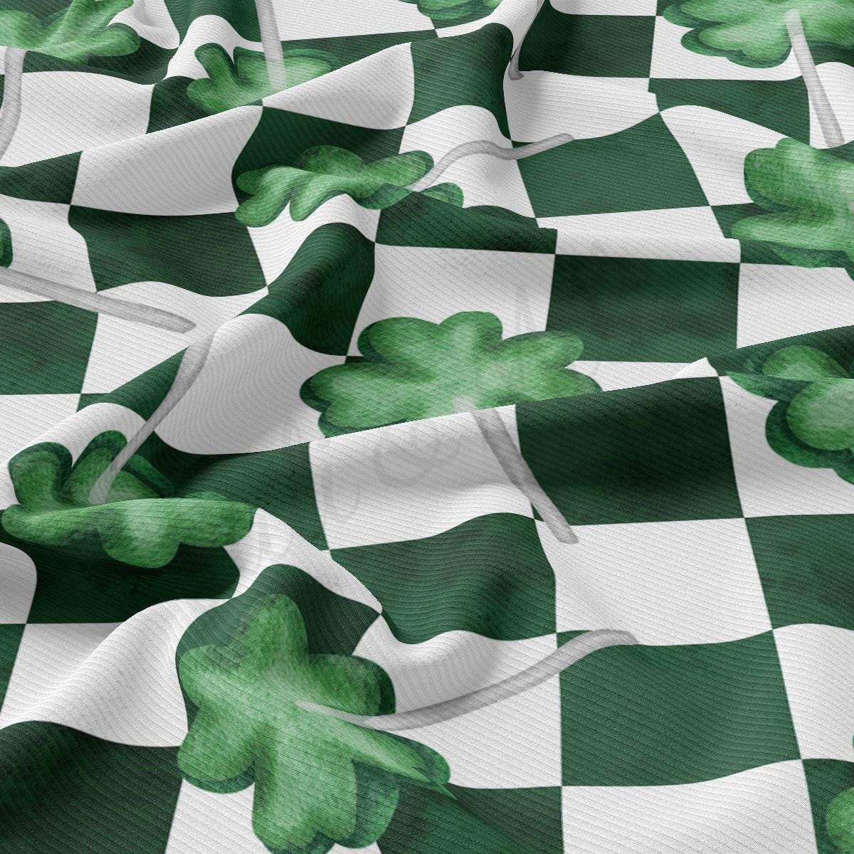 a green and white checkered fabric with shamrocks on it