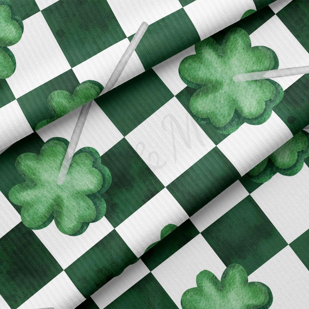 a green and white checkered fabric with shamrocks on it