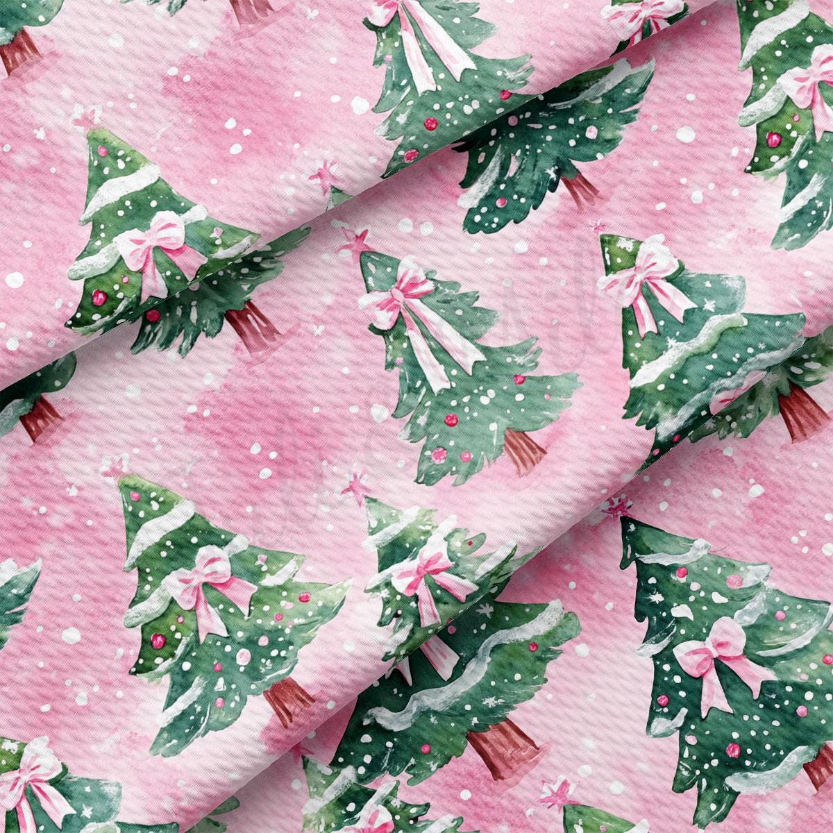 a repeating pattern of Christmas trees with pink bows on a pink background.