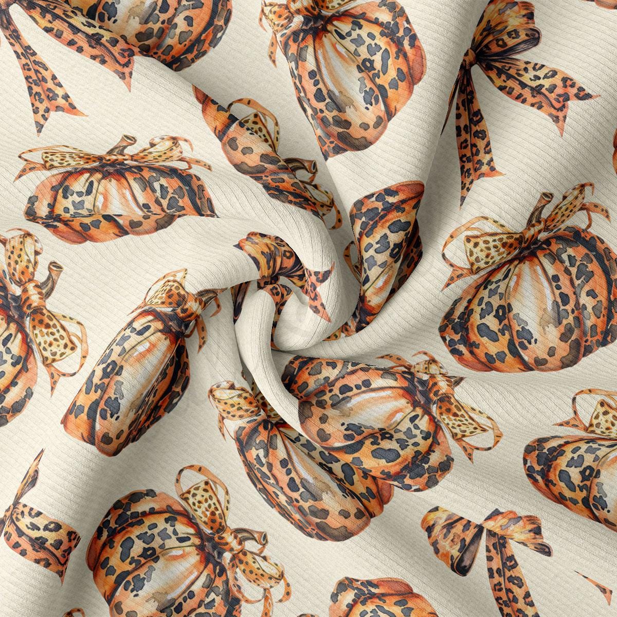 a close-up view of a fabric with a repeating pattern of leopard print pumpkins and bows.